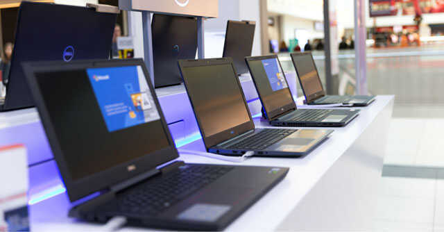 PC maker Dell reports record quarterly income, demand slump to shrink annual revenue